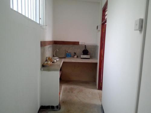a small kitchen with a sink in a room at Villa Maleena in Hikkaduwa