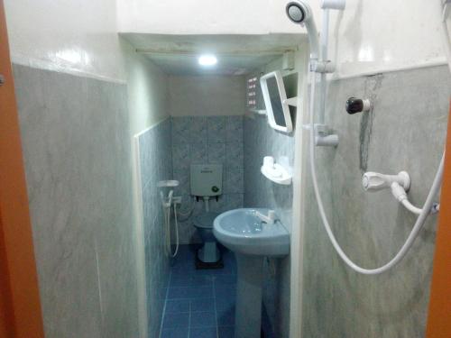 a small bathroom with a sink and a toilet at Villa Maleena in Hikkaduwa