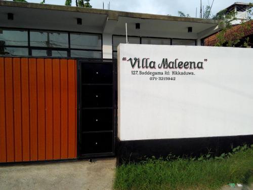 a building with a sign that reads villa medicario at Villa Maleena in Hikkaduwa
