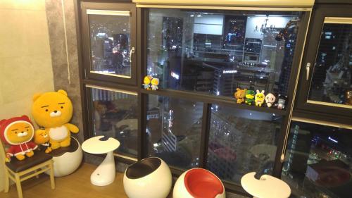 a group of stuffed animals sitting in front of a window at Dynamic Guesthouse in Busan