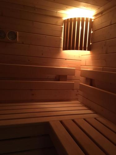 a wooden sauna with a light in the middle at Maison de la Garenne & Spa in Vannes