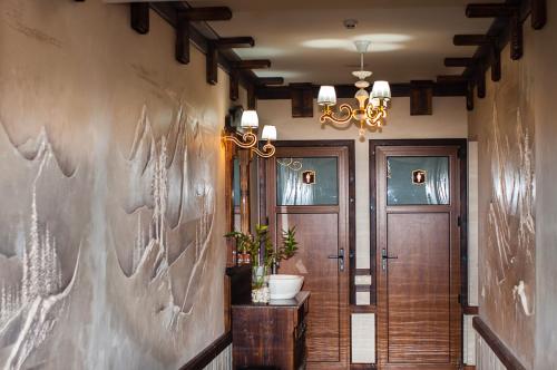 a hallway with a door and a chandelier at SPA Resort HeRICH in Bukovel