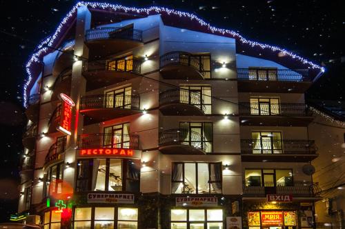 a building with christmas lights on top of it at SPA Resort HeRICH in Bukovel