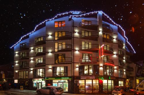 a building with christmas lights on top of it at SPA Resort HeRICH in Bukovel
