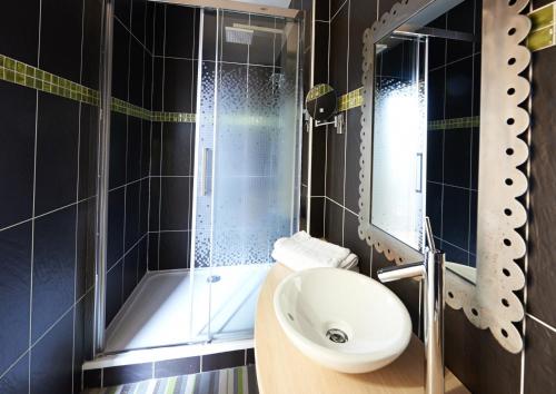 a bathroom with a toilet and a sink and a shower at Villa Bon Repos in Argelès-Gazost