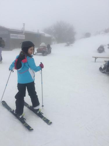 a young girl is on skis in the snow at Villa Vager in Levidhion