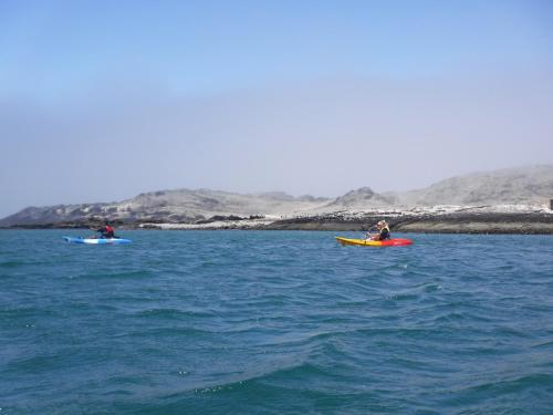 two people kayaking on the water in the ocean at Alte Villa Boutique Hotel in Lüderitz