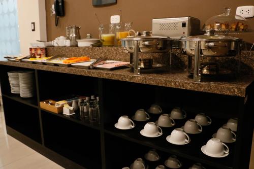 a kitchen with a counter with pots and pans at Hotel Solec in Chiclayo