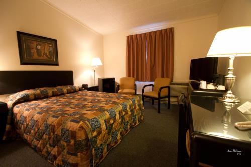 a hotel room with a bed and a desk at Hotel Port Aux Basques in Channel-Port aux Basques