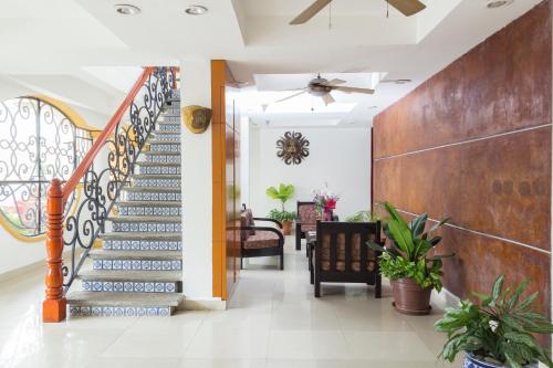 a staircase in a living room with a ceiling fan at Hotel Madan Cárdenas in Cárdenas