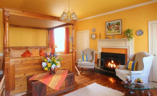 a living room with a fireplace and a fire place at L'Auberge Provencale Inn & Restaurant in Boyce