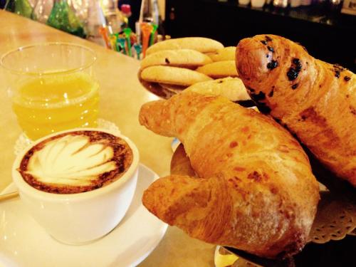 a plate of food with bread and a cup of coffee at Best Western Premier BHR Treviso Hotel in Quinto di Treviso