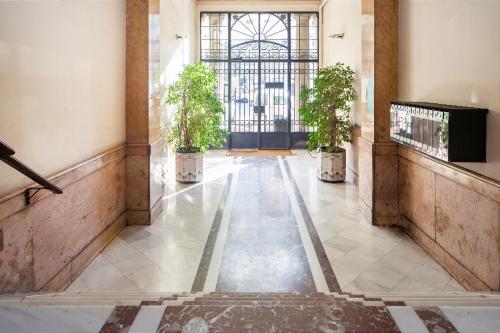 a hallway with potted plants in a building at Bailén Green House in Barcelona