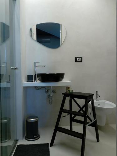 a bathroom with a sink and a mirror on the wall at Ananke B&B in Bisceglie
