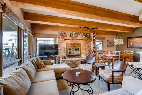 a living room with a couch and a fireplace at The Plaza Condominiums by Crested Butte Mountain Resort in Mount Crested Butte