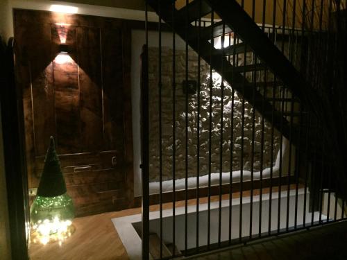 a room with a staircase with a christmas tree on the floor at Il Peschio in Pescocostanzo