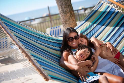 two women and a child laying in a hammock at Hotel Blue in Myrtle Beach