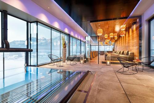 a lobby with a table and chairs and a couch at Hotel Penzinghof in Oberndorf in Tirol