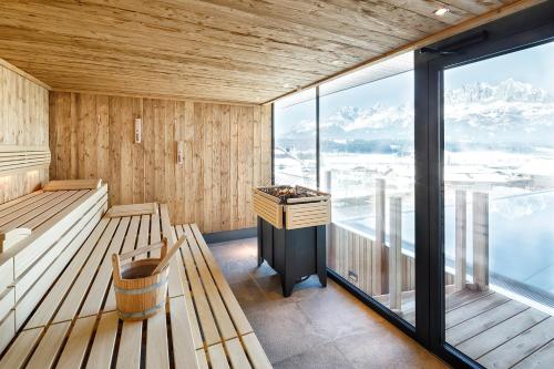 a sauna with a view of the mountains at Hotel Penzinghof in Oberndorf in Tirol
