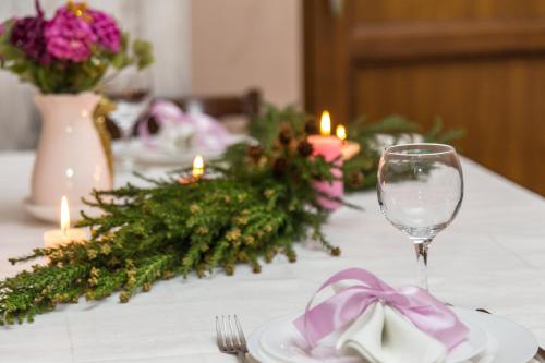 a table with a purple bow and a wine glass at Atlant Hotel in Tbilisi City