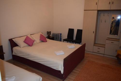 a bedroom with a bed with two pillows on it at Apartment S&M in Tivat