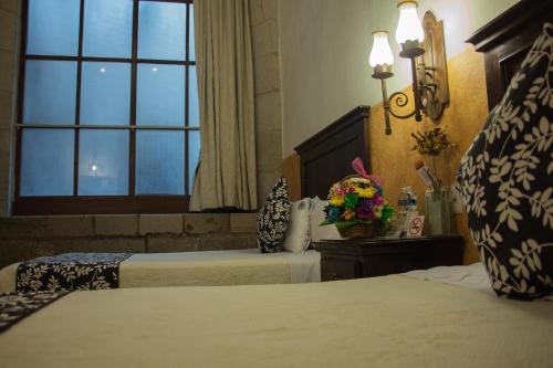 Postel nebo postele na pokoji v ubytování Hotel Historia