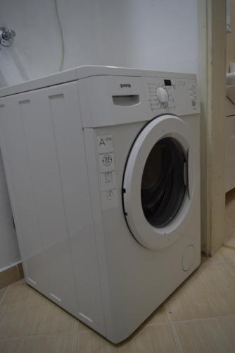 a white washing machine sitting in a room at Apartment S&M in Tivat