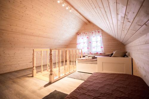 a small room with a bed and a window at Baltic Dream Vasarnamiai in Šventoji