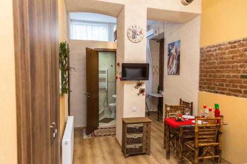 a living room with a table and a dining room at Atlant Hotel in Tbilisi City