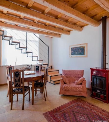 a living room with a table and chairs and a staircase at Affittacamere Borgocapo in Roccamontepiano