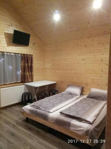 a room with two beds and a table in it at Turul in Berehove