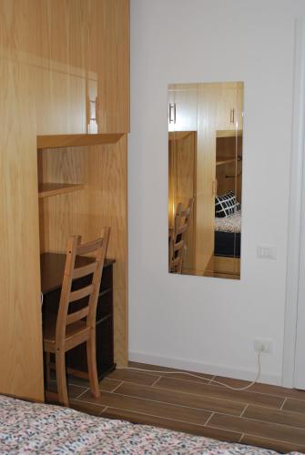 a room with a chair and a mirror at Bed and Breakfast Bio Salix in Padova