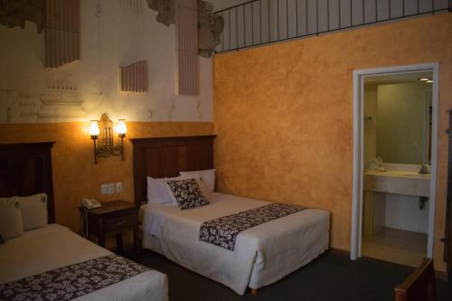 Postel nebo postele na pokoji v ubytování Hotel Historia