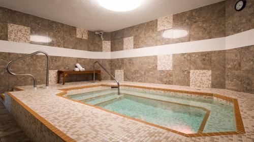 a large swimming pool in a room with a tile wall at Best Western PLUS Inner Harbour Hotel in Victoria