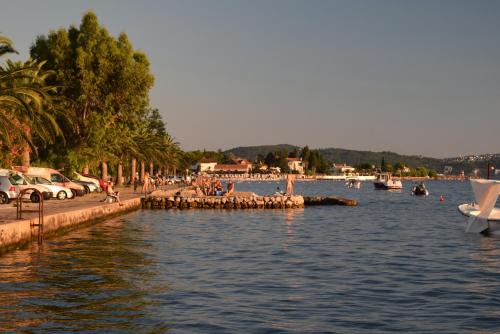 a body of water with a group of people on a dock at Apartment S&M in Tivat