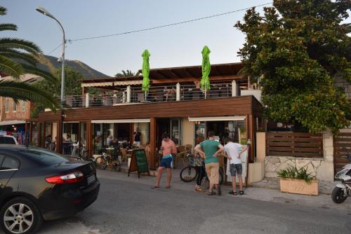 a group of people standing outside of a restaurant at Apartment S&M in Tivat