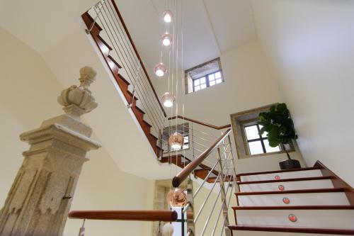 a staircase in a house with a spiral stair case at Pazo de Mendoza in Baiona