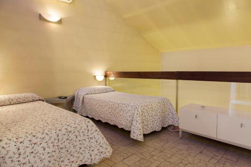 a hotel room with two beds in a room at Affittacamere Europa Fiera in Rho