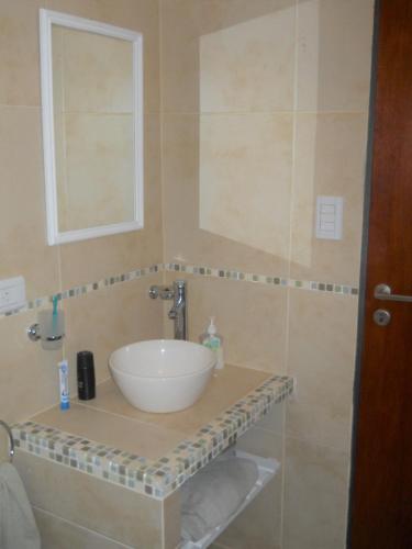 a bathroom with a sink and a mirror at Casa Crisolito in Merlo