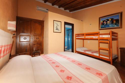 a bedroom with a bunk bed and a bunk bed at Santa Maria Resort in Orosei