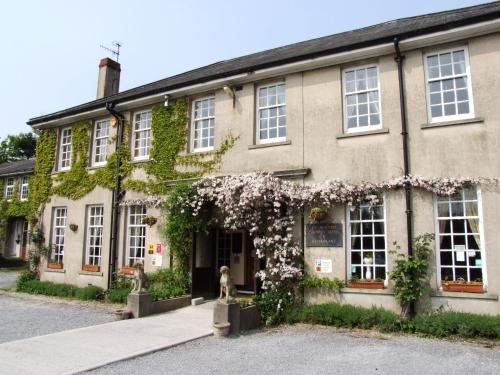 a building with flowers on the front of it at Ty Newydd Country Hotel in Hirwaun