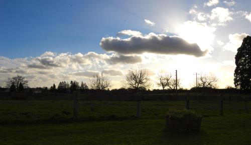 a cloud in the sky over a field at Hôtel de Tessé in Bagnoles de l'Orne
