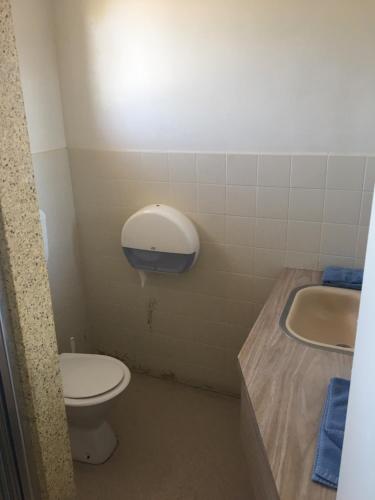 a bathroom with a toilet and a sink at Yarram Commecial Hotel Motel in Yarram