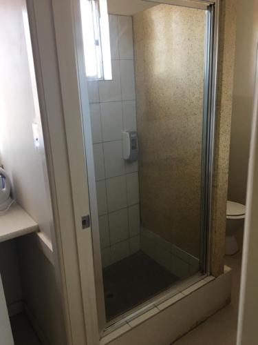 a shower with a glass door in a bathroom at Yarram Commecial Hotel Motel in Yarram