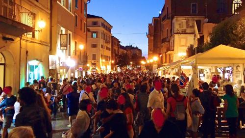 a crowd of people walking down a street at night at Monolocale turistico Valentini in Albano Laziale