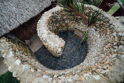 a rock garden with a plant in the middle at Aore Island Resort in Luganville