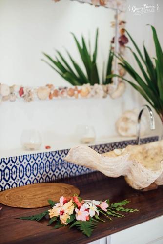 a table with a cutting board and flowers on it at Aore Island Resort in Luganville