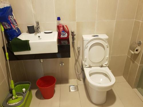 a bathroom with a white toilet and a sink at Relaxing Studio@Cyber in Cyberjaya