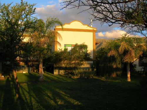 a white building with trees in front of it at Posada Los Antiguos-Adults Only in Merlo
