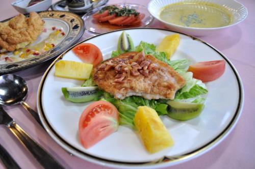 um prato de comida com peixe e legumes numa mesa em Pension Risuno Koya em Hakuba